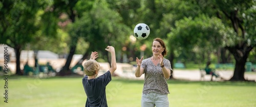 Obraz na płótnie grandmother and grandson bonding joyful family moment playing soccer together