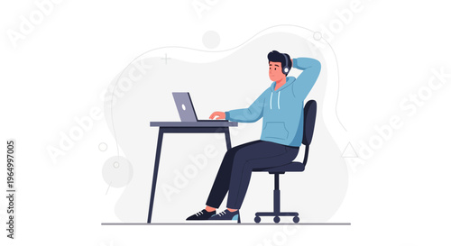 Young man with headphones working on laptop at desk, relaxed posture