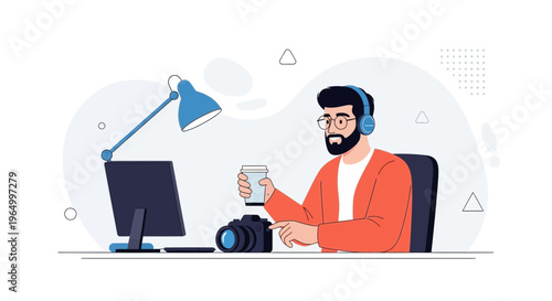 Creative freelancer working on computer with camera and coffee