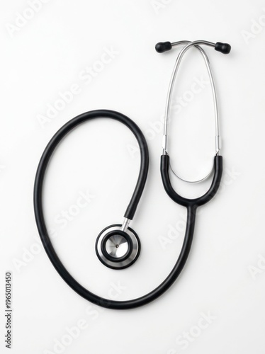 A black stethoscope rests on a white background. The medical instrument has a shiny chrome tubing and black earpieces.