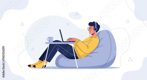 Young man with headphones working on laptop on bean bag chair, remote work concept