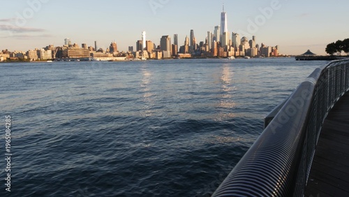 New York City Manhattan Downtown Financial District skyline, World Trade Center tower from New Jersey, Hoboken pier, United States of America. River waterfront urban cityscape with skyscraper building