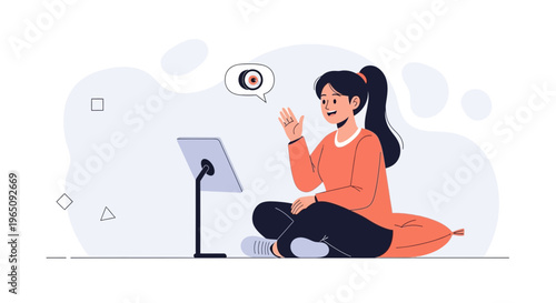 Young woman waving hello on video call, sitting cross-legged on a pillow