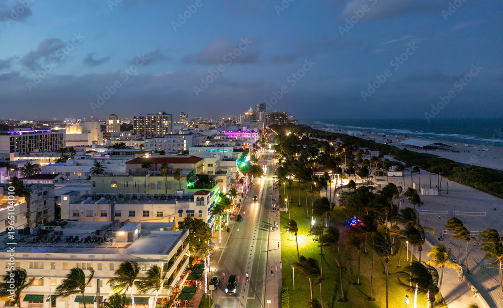 Obraz premium Top view of South Miami with Ocean Drive at evening. Aerial view of Miami with Ocean Drive at night. Panoramic Miami evening coastline with Ocean Drive. Miami shoreline on Ocean Drive.