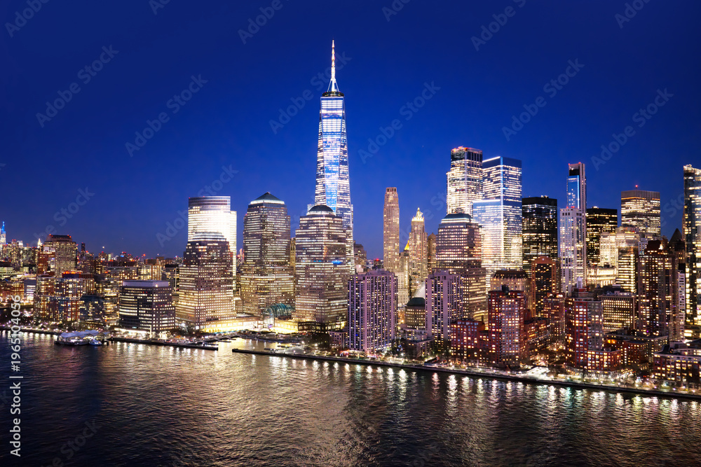 Obraz premium NYC panoramic view of the Lower Manhattan skyline. New York City aerial skyline panorama. New York urban landscape. NYC night cityscape with Manhattan skyline. New York City wide panoramic skyline.