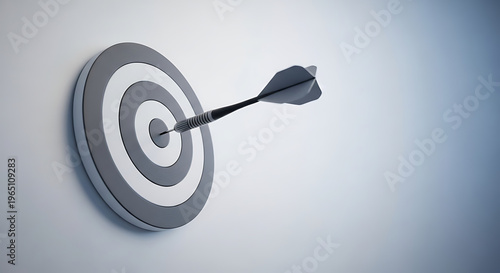 A single black dart perfectly hits the bullseye of a grey and white target board, symbolizing precision and goal achievement.