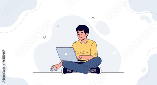 Young man sitting cross-legged with laptop and mouse, working remotely