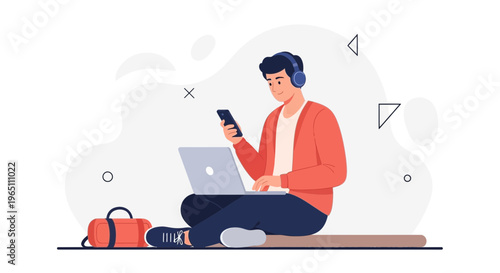 Young man with headphones using laptop and phone, working remotely, with gym bag