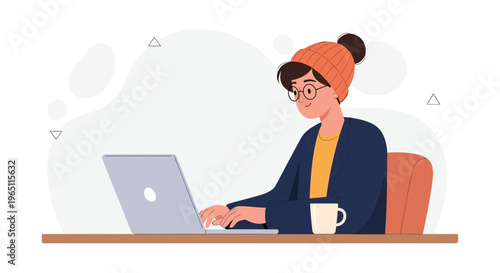Young person in beanie and glasses working on laptop with coffee cup