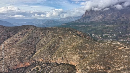Foothill ridge mapping from drone over scrubland, contour lines visible on slopes, cloud shadow, scientific