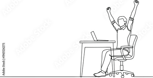 Man celebrating success at his desk with arms raised in triumph