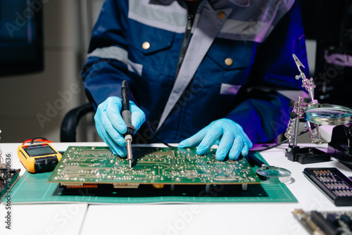 Close up of soldering circuit board, electronics repair process, PCB engineering, hardware maintenance