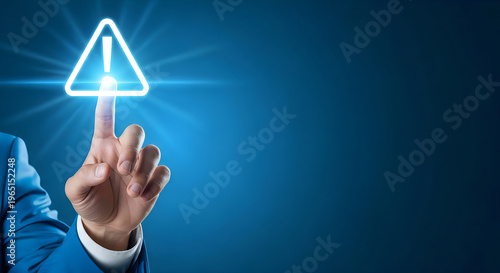 Businessman touching a glowing warning sign on a blue background with caution