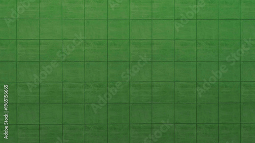 Abstract backdrop featuring a seamless arrangement of green square tiles, creating a geometric and visually appealing textured surface