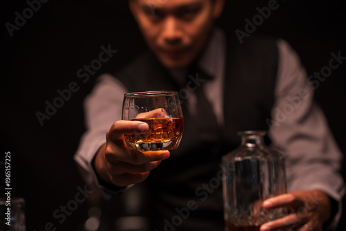 Bartender Holding Out a Glass of Premium Whiskey to Customer