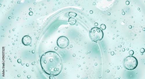 Transparent cosmetic gel texture with bubbles on light blue background, hydrating serum surface, hygiene liquid soap macro, clean skin care product