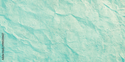Crinkled turquoise paper texture background with creases and wrinkles for design elements