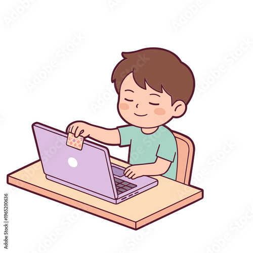 A boy sits at a desk using a laptop computer with a smile