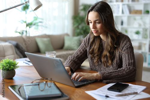 Tele worker working online at home using laptop