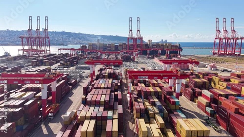 Aerial drone Haifa port containers cranes Mediterranean coastline Israel

Drone footage container terminal with cranes cargo stacks and parked vehicles Haifa port Israel 1.1.2026
