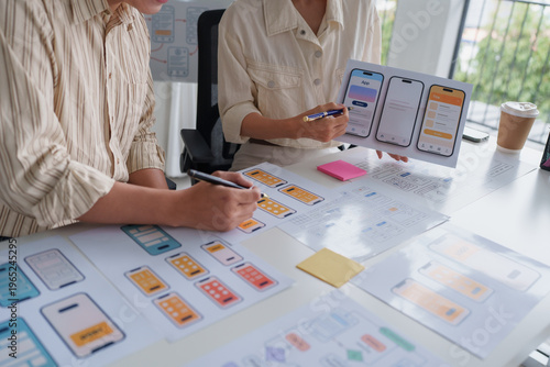 Designers collaborating on mobile application ui ux design