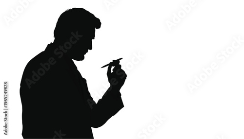Silhouette of a professional inspecting a small instrument with focused attention against a white background.