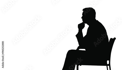 Side profile silhouette of a pensive man sitting down with his hand resting thoughtfully against his chin.