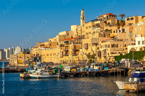 Old buildings of Yafo overlooking small port on Mediterranean sea.