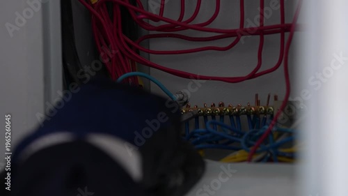 Electrician Installing Electric Meter on Wall Panel — Close Up Detail
