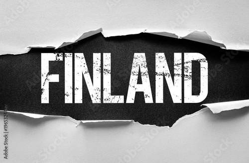 Word FINLAND revealed through a torn paper background with a grunge texture. Concept image for travel, destination, culture, politics, tourism, or European identity with a dramatic effect
