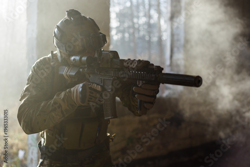Fotografija Special forces soldier with skull mask and carbine in abandoned building