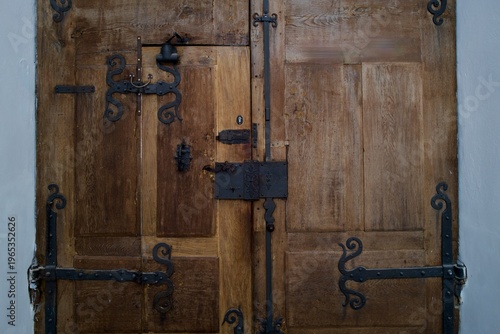 Vintage Wooden Door with Ornate Wrought Iron Hinges and Lock