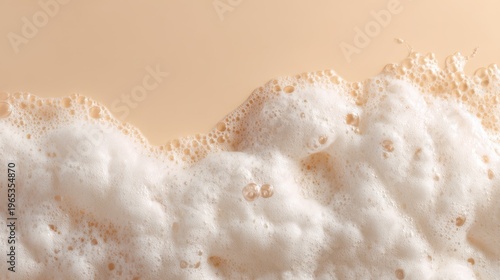 White soap foam on beige background. Bubbles of shampoo texture for liquid cleansing product. Concept of body care and beauty hygiene. Fresh cosmetic sensation with empty copy space.