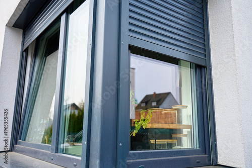 Fotografía Close up of modern house window with roller shutter over glass on exterior facade