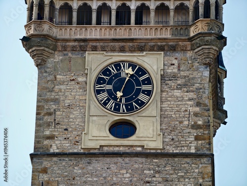 Old clock with decorative face. Landmark structure featuring weathered stone and classical clock design