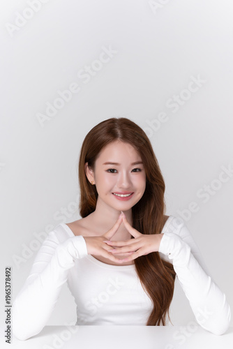 portrait beautiful young asian woman with brunette hair, healthy glowing facial skin and natural makeup on white background, for advertising cosmetics and beauty concept.