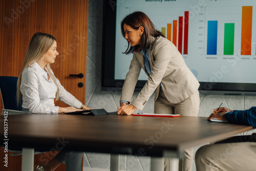 Businesswoman confronting employee during office meeting