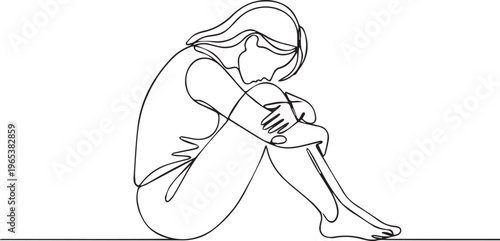 A woman sits alone with her head bowed and arms wrapped around her knees in a contemplative or melancholic pose