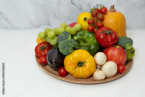 Colorful Fruits and Vegetables Assortment on Wooden Plate