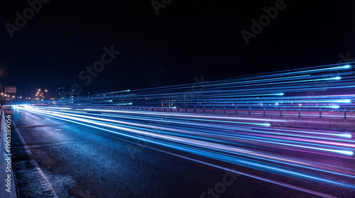 Photos Long exposure photograph of vibrant blue and purple light trails on a highway at night