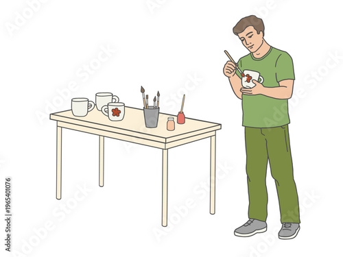 Man hand painting ceramic mugs at work table