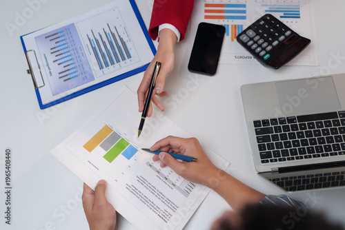 Business people analysing financial data and reports together