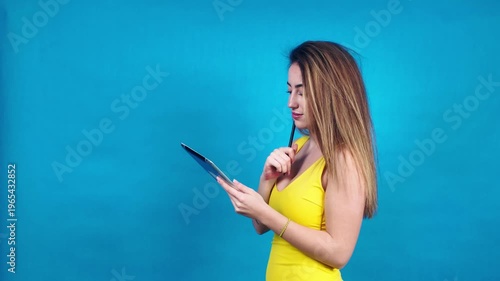 Young woman using digital tablet and stylus for work