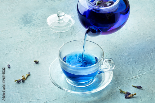 Blue tea, an infusion of butterfly pea flowers, being poured into a cup
