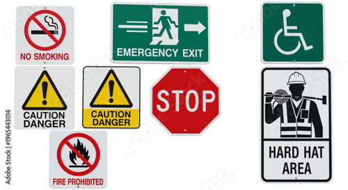 A collection of various warning and danger signs displayed together indoors.