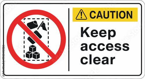 A caution sign with an illustration warns to keep access clear in an industrial area.
