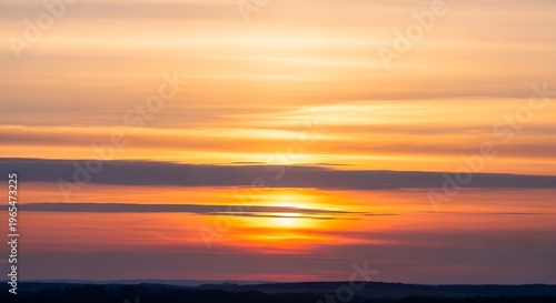 Beautiful sunset sky with dramatic orange clouds over horizon