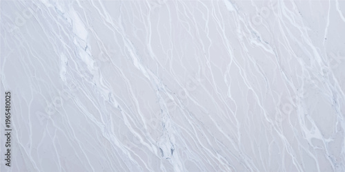 An abstract blue water surface ripples with a frozen white texture, blending winter frost and snowy patterns into a cold nature background of ice and sky