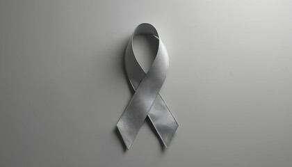 Silver awareness ribbon on gray background. Symbol for brain tumor disease and suicide prevention. Represents hope, support, and medical care.