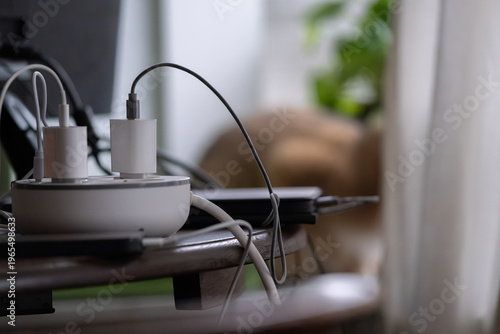 Charging cables and power adapters on table, modern technology lifestyle concept